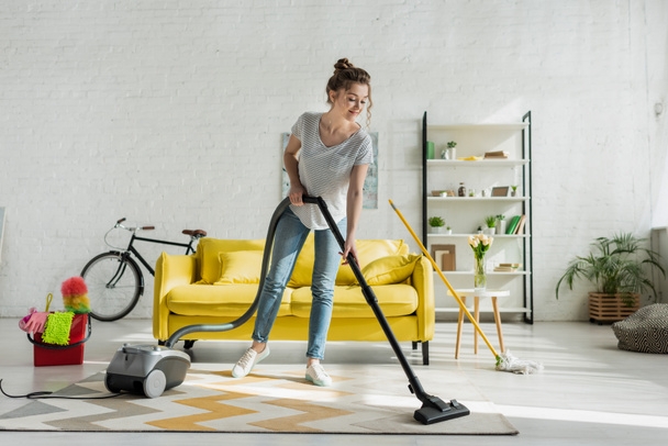 Women clean her carpet using vacuum cleaner