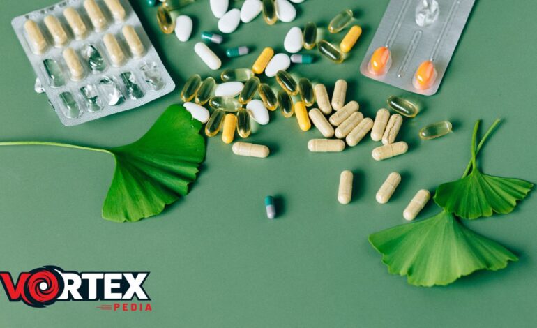 In this image medicines are lying with some leaves with green background.