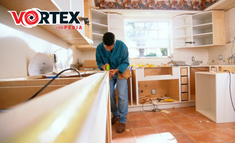 A man is remodeling the kitchen with so focus.