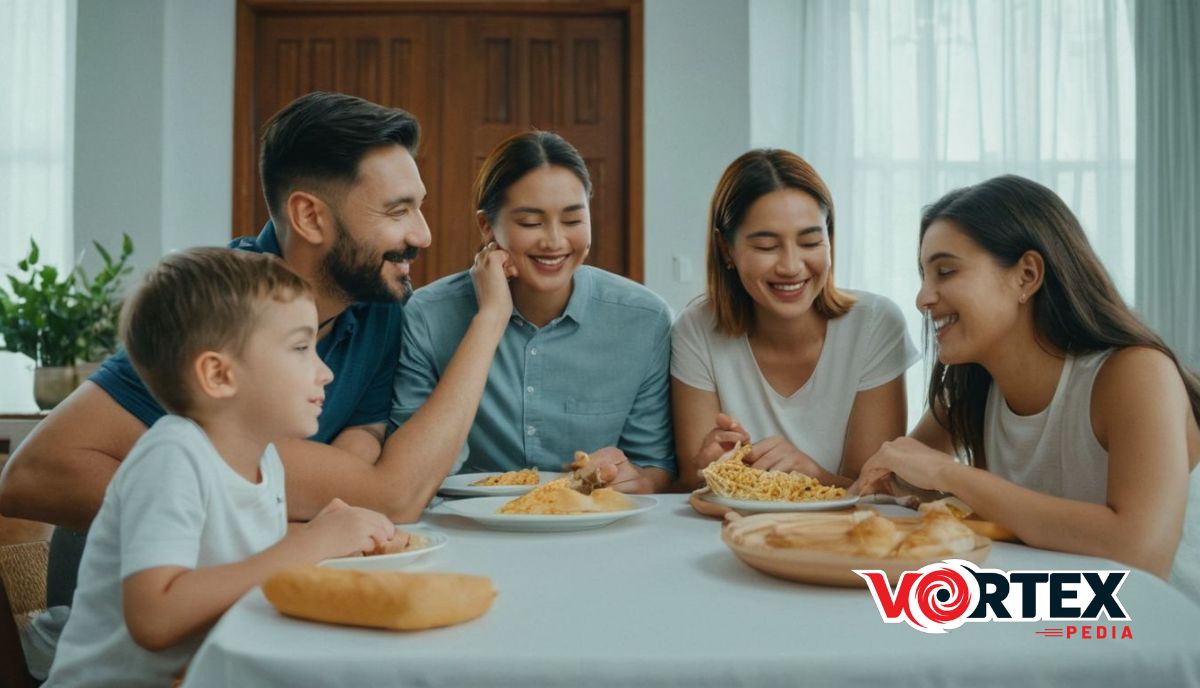 A family of five sitting at a table eating a meal together.