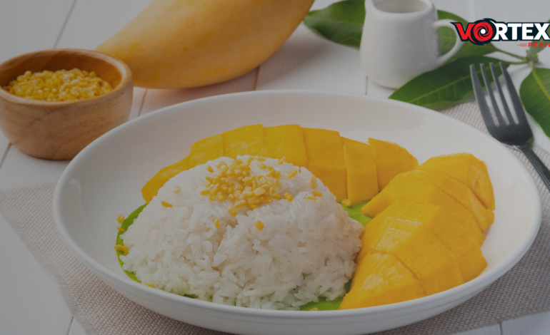 Perfect Rice Less Sticky Or Clumpy lay in a dish with mango.