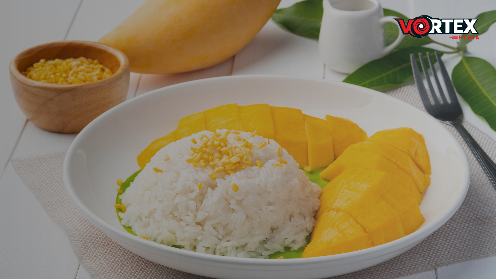 Perfect Rice Less Sticky Or Clumpy lay in a dish with mango.