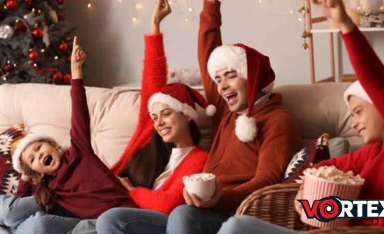 A family is watching the movie and wearing Christmas dresses enjoying the season.